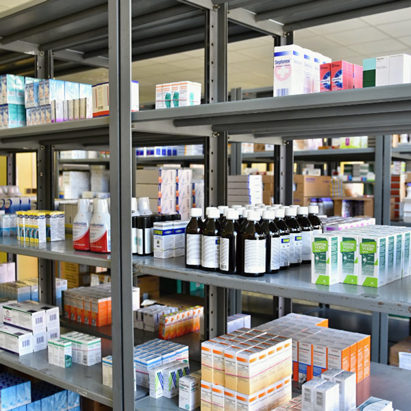 A well-stocked pharmacy displaying shelves filled with various medicines for sale.